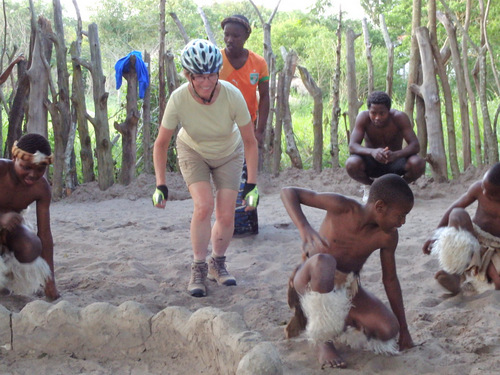 Terry is performing Zulu dance steps in a Zulu Village.